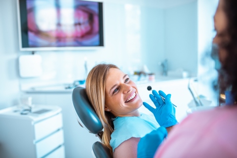 Woman having her teeth checked by a dentist - proper dental health concept.