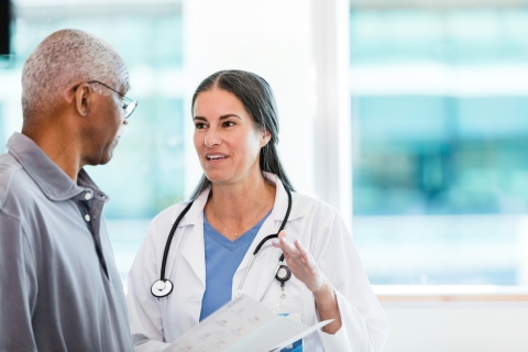 Female doctor speaking with a senior patient in a hospital - choosing the right doctor.