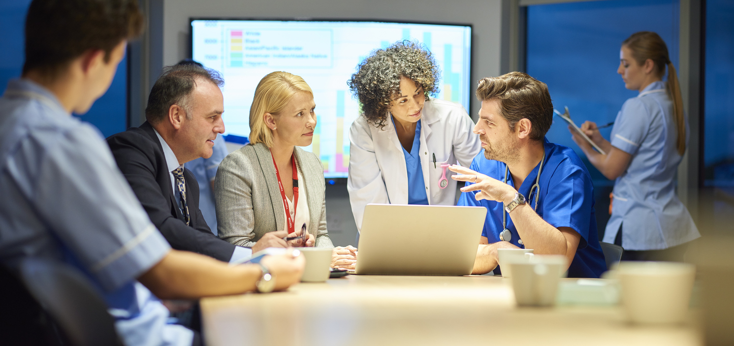 group of doctors having meeting in board room