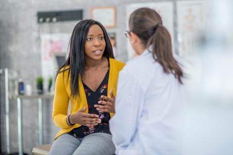 woman speaking with doctor in doctor's office